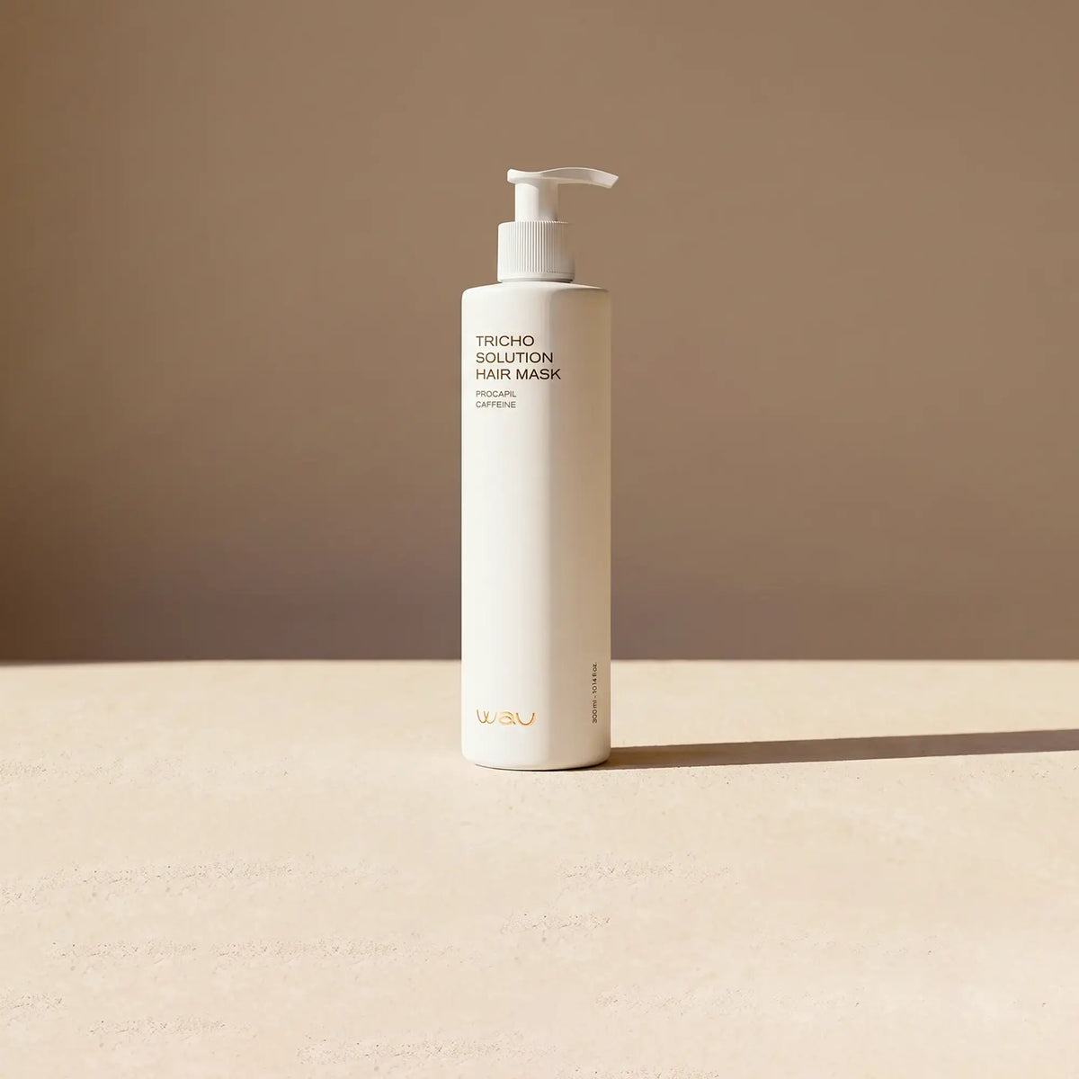 Tricho Solution Hair Mask bottle on a beige surface, promoting hair growth mask benefits.