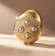 KIO MASSAGER in gold design with four silver balls for effective body contouring and skin tightening.